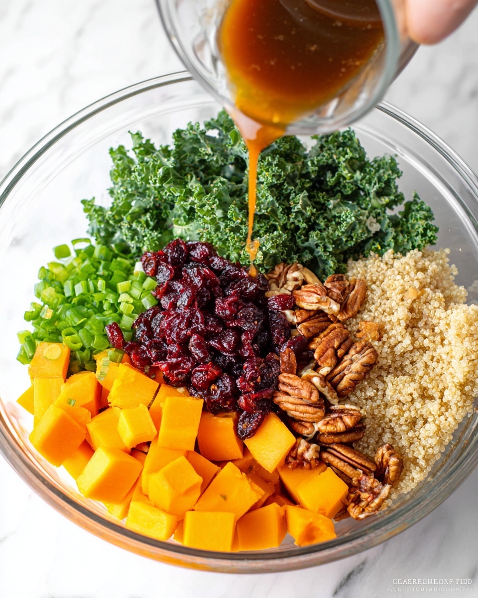 In a clear bowl on a white marbled surface, there are six different layers of salad ingredients arranged in segments: bright orange cubed squash at the front, finely chopped green onions to the left, dark green leafy kale next to the green onions, glossy red dried cranberries in the center, light beige cooked quinoa to the right, and a pile of brown pecan nuts above the quinoa. A woman's hand pours a shiny brown dressing onto the cranberries from a small clear glass container, creating a slight drizzle. The textures range from soft squash, crunchy nuts, fluffy quinoa, leafy kale, and chewy cranberries, with vivid natural colors. photo taken with an iphone --ar 4:5 --v 7