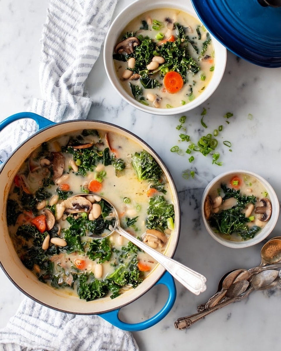 A large white pot filled with a light creamy soup that has visible layers of chopped carrots, sliced mushrooms, white beans, and dark green kale floating on top. Two white bowls hold servings of the same soup with a silver spoon in one, all placed on a white marbled surface. There are also two spoons lying beside the bowls, a glass of water, a small dish with a lemon cut in half, some parsley leaves, and a loaf of brown bread on a cloth napkin. The scene shows a cozy, fresh meal setting. Photo taken with an iphone --ar 4:5 --v 7