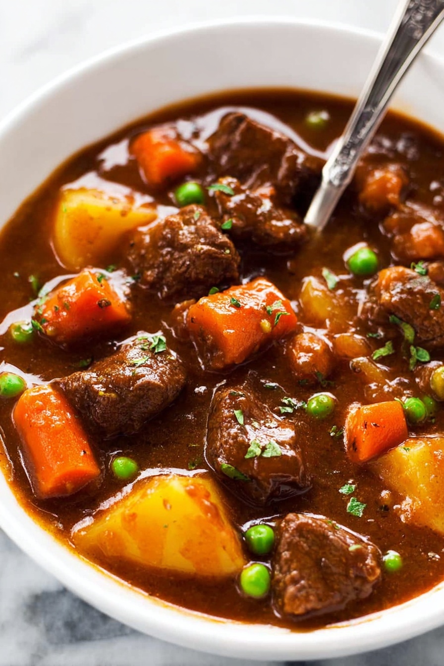 This image shows a thick brown stew filled with several pieces of tender beef, bright orange carrot chunks, and a few green peas scattered throughout. The stew has a rich, smooth, and slightly glossy sauce that coats the meat and vegetables evenly. A large metal ladle in the center lifts a portion of the stew, highlighting the chunky texture of the ingredients and the thick, savory gravy dripping slowly. The background is a white marbled surface. photo taken with an iphone --ar 2:3 --v 7 - Slow Cooker Beef Stew, hearty beef stew, easy beef stew recipe, comforting slow cooker meal, tender beef and veggie stew