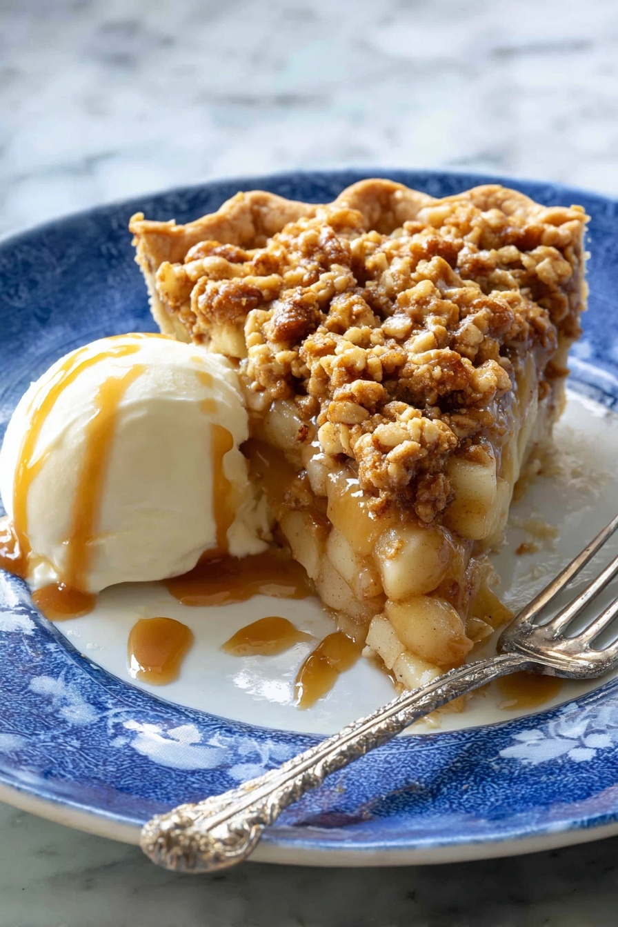 A slice of pie with three layers sits on a white plate with a blue pattern: the bottom is a light brown crust, the middle layer is soft apple chunks mixed with caramel sauce, and the top layer is a crumbly, golden brown oat topping with small pieces of nuts. Next to the pie is a scoop of white ice cream covered with caramel sauce. A silver fork with a twisted handle rests on the plate near the pie. The background has a white marbled texture. Photo taken with an iphone --ar 2:3 --v 7 - Apple Crisp Pizza, easy apple dessert, fall dessert recipes, cinnamon apple treat, unique pizza desserts