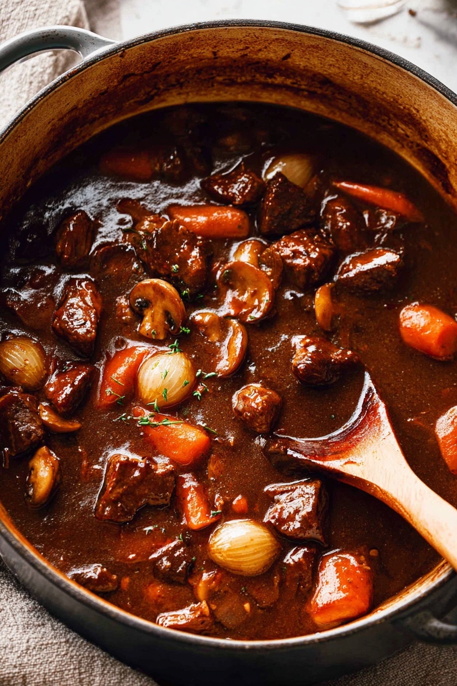 A large pot filled with a thick, dark brown stew containing visible chunks of browned meat, orange carrot slices, small whole pearl onions, and mushrooms, all coated in a shiny sauce. The stew is being stirred by a wooden spoon positioned on the right side inside the pot. The pot sits on a white marbled surface with a textured background of light fabric. Photo taken with an iphone --ar 2:3 --v 7 - Beef Bourguignon, Beef Burgundy, French beef stew, classic French recipes, hearty French stew