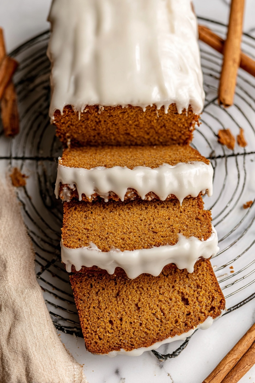 The image shows a loaf of brown cake with three slice pieces cut from it, stacked and spread out below the rest of the loaf. The top of the cake and the edges of the slices have a thick layer of white icing that looks smooth but slightly melted, dripping down the sides. The cake has a dense, moist texture with visible small holes inside. The loaf rests on a round metal wire cooling rack placed on a white marbled surface with a beige cloth and cinnamon sticks nearby. Photo taken with an iphone --ar 2:3 --v 7 - Healthy Pumpkin Bread with Maple Glaze, healthy pumpkin bread, fall pumpkin bread recipe, nutritious pumpkin loaf, cozy spice pumpkin bread