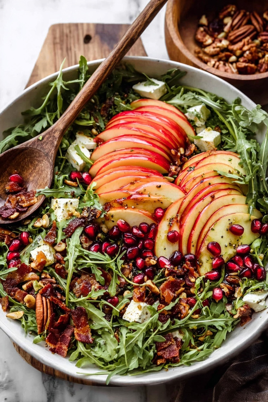 A white bowl filled with a fresh salad layered with bright green arugula leaves as the base, topped with thinly sliced red apple pieces arranged in neat rows across the top. Scattered among the arugula and apples are dark red pomegranate seeds, crunchy toasted seeds and nuts with a golden brown color, small chunks of creamy white cheese, and some crispy bacon bits with a deep reddish-brown hue. A wooden spoon rests on the side of the bowl, and the scene is set on a white marbled surface with a wooden bowl in the background. Photo taken with an iphone --ar 2:3 --v 7 - Autumn Harvest Honeycrisp Apple and Feta Salad, fall apple salads, honeycrisp apple recipes, healthy apple salad, seasonal fall salads