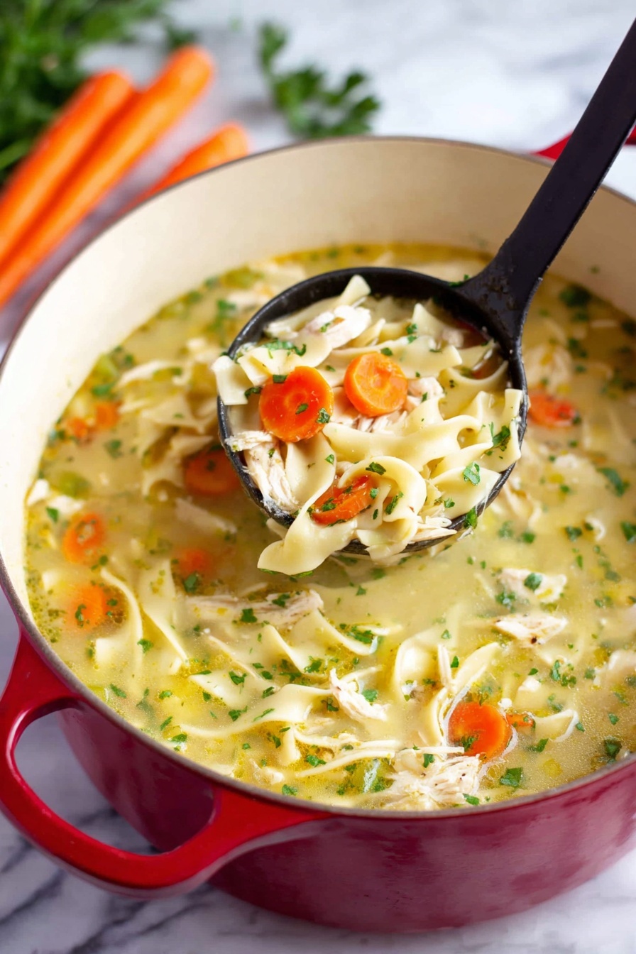 The image shows a red pot filled with chicken noodle soup placed on a white marbled surface. The soup has three main layers: a light yellow broth as the base with visible small green herbs scattered throughout; chunky pieces of white chicken and thick flat noodles spread evenly; and slices of orange carrot and green celery mixed in. A black ladle lifts a portion of soup, showing a close-up of a mix of chicken, noodles, carrot, and celery. In the background, there are some whole carrots and green parsley visible. Photo taken with an iphone --ar 2:3 --v 7 - Easy Chicken Noodle Soup, homemade chicken noodle soup, hearty chicken soup, comforting chicken soup recipe, quick chicken noodle soup