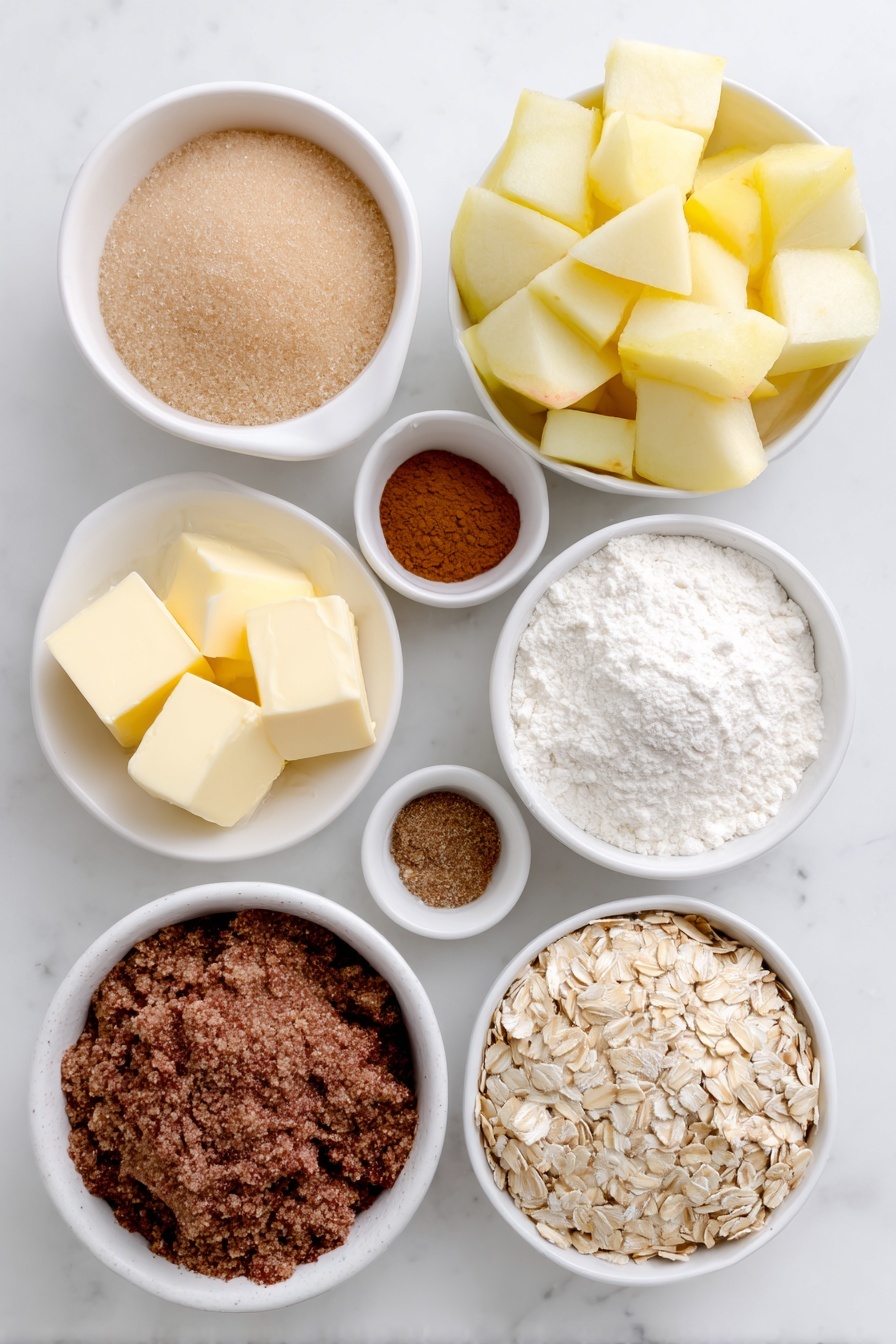 Flat lay of fresh peeled apple chunks with smooth pale yellow flesh, a small white ceramic bowl of packed light brown sugar, a small white ceramic bowl of all-purpose flour with fine white powder, a small white ceramic bowl of ground cinnamon with warm reddish-brown color, a small white ceramic bowl of ground nutmeg with medium brown color, a small white ceramic bowl of fine salt crystals, cold unsalted butter cut into neat cubes with a creamy pale yellow color arranged on a white ceramic plate, a small white ceramic bowl of old-fashioned whole rolled oats with natural beige flakes, and a small white ceramic bowl of pure vanilla extract liquid with pale golden hue, all arranged symmetrically on a clean white marble surface, soft natural light, photo taken with an iPhone, professional food photography style, fresh ingredients, white ceramic bowls, no bottles, no duplicates, no utensils, no packaging --ar 2:3 --v 7 --p m7354615311229779997 - Easy Classic Apple Crisp, apple crisp dessert, easy apple dessert, comforting apple crisp, simple apple crumble