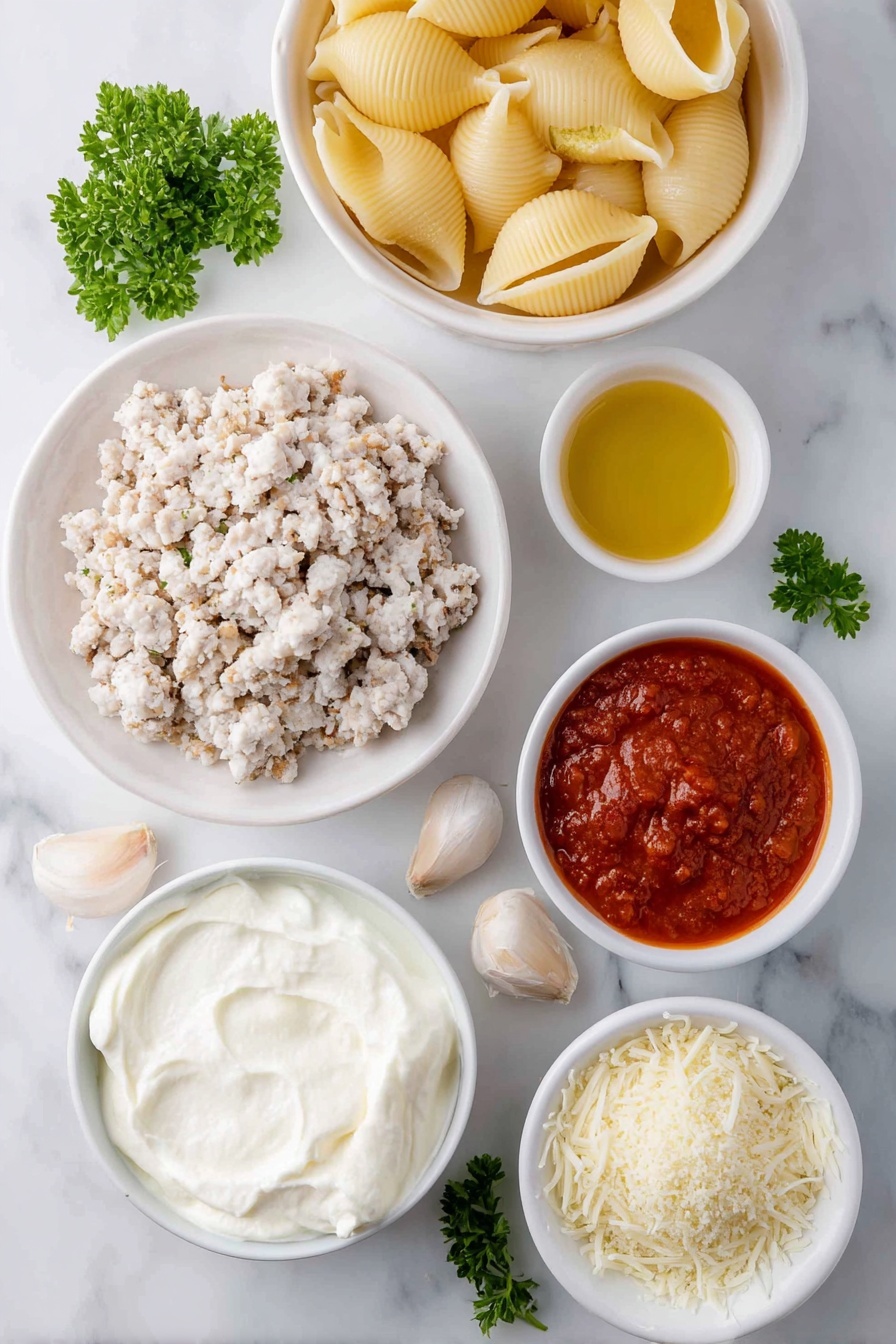 Flat lay of jumbo pasta shells arranged next to a small white bowl of olive oil, a mound of ground chicken pieces seasoned with dried Italian herbs and salt, a large white ceramic bowl filled with creamy whole milk ricotta cheese, a small white bowl holding shredded mozzarella cheese, another small white bowl with grated Parmesan cheese, one whole uncracked large egg with a clean shell, four peeled garlic cloves, a small white bowl containing vibrant red marinara sauce, a small white bowl of light golden Panko breadcrumbs, and a few fresh sprigs of chopped parsley scattered nearby, all placed on a clean white marble surface, soft natural light, photo taken with an iPhone, professional food photography style, fresh ingredients, white ceramic bowls, no bottles, no duplicates, no utensils, no packaging --ar 2:3 --v 7 --p m7354615311229779997 - Chicken Parmesan Stuffed Shells, Italian stuffed shells, cheesy chicken pasta, baked stuffed shells, easy chicken shell recipe