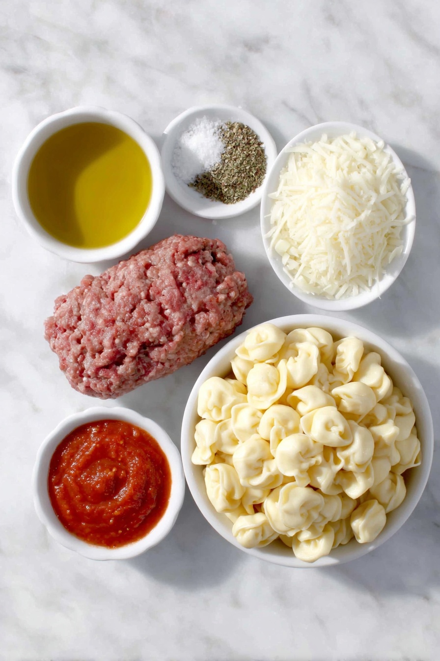 Flat lay of a small white ceramic bowl of golden olive oil, a handful of fresh lean ground beef, a small white ceramic bowl with diced white onion, three peeled garlic cloves, a small white ceramic bowl of crushed bright red tomatoes, a small white ceramic bowl of smooth red tomato sauce, a small white ceramic bowl containing dried Italian seasoning herbs, a small white ceramic bowl of kosher salt crystals, a small white ceramic bowl of freshly ground black pepper, a generous mound of fresh cheese tortellini pasta, and a small white ceramic bowl heaped with freshly grated mozzarella cheese, all arranged in perfect symmetry on a clean white marble surface, soft natural light, photo taken with an iPhone, professional food photography style, fresh ingredients, white ceramic bowls, no bottles, no duplicates, no utensils, no packaging --ar 2:3 --v 7 --p m7354615311229779997 - Baked Tortellini Casserole with Cheese, cheesy tortellini bake, easy tortellini casserole, baked pasta recipes, comfort food dinner