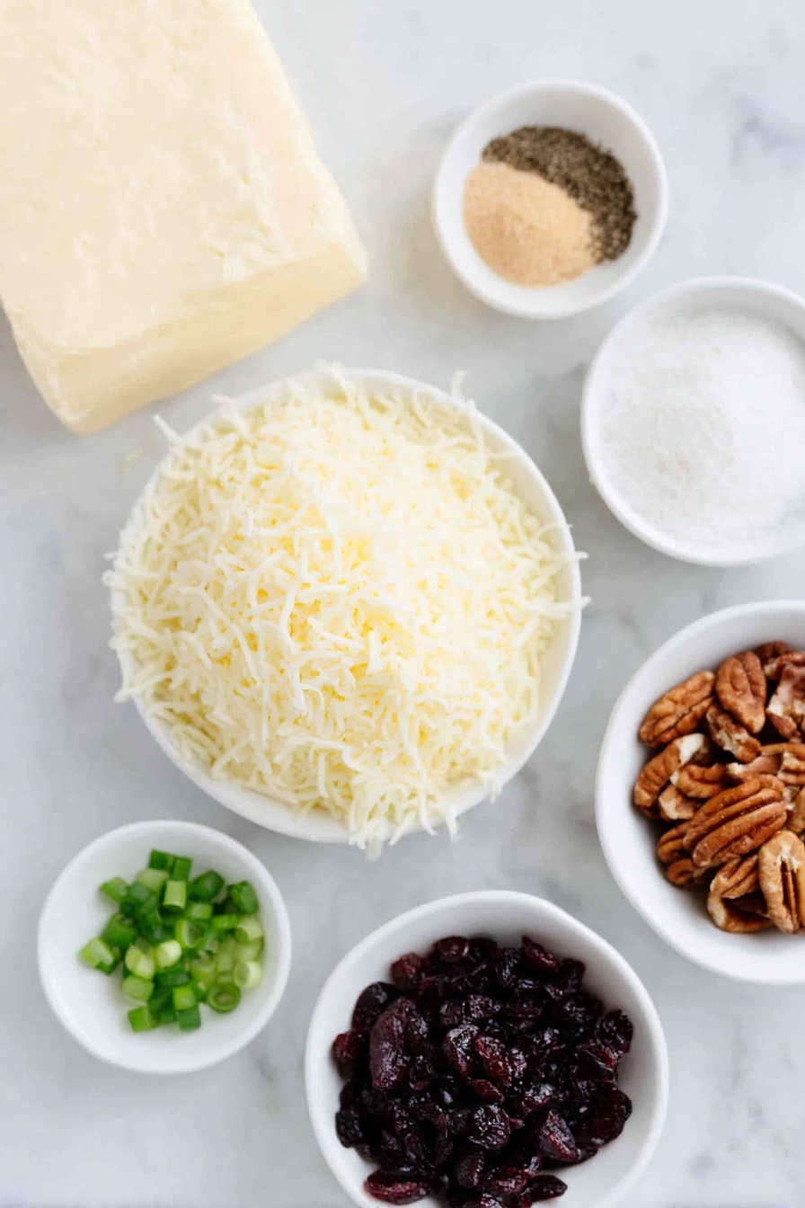 Flat lay of a block of full-fat cream cheese softened, a small heap of shredded sharp white cheddar cheese, a few sprigs of chopped fresh green onions, a small white bowl of light brown sugar, a small white bowl of garlic powder, a small white bowl of fine salt, a small white bowl of ground black pepper, a small white bowl of finely chopped dried cranberries, and a small white bowl of finely chopped pecans, all arranged in perfect symmetry on a clean white marble surface, soft natural light, photo taken with an iPhone, professional food photography style, fresh ingredients, white ceramic bowls, no bottles, no duplicates, no utensils, no packaging --ar 2:3 --v 7 --p m7354615311229779997 - Cranberry Pecan Cheese Ball, holiday appetizer cheese ball, festive cheese ball recipe, easy cheese ball appetizer, cranberry pecan cheese ball