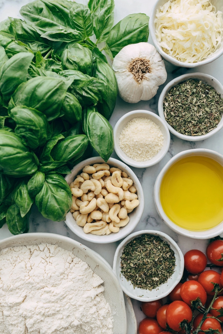 Flat lay of fresh bright green basil leaves and a few sprigs of mixed leafy herbs, a small pile of raw Australian macadamia nuts, two whole uncracked garlic cloves, a small white bowl of golden extra virgin olive oil, a small white bowl of nutritional yeast flakes, a small white bowl of lemon juice, a small white bowl of coarse sea salt, a mound of smooth all-purpose flour, a small white bowl of warm dairy-free milk, a chunk of soft vegan butter, a small white bowl of granulated sugar, a small white bowl of instant dry yeast granules, a small white bowl of mixed dried herbs, a scattering of whole and crushed raw macadamia nuts, and a handful of glossy red cherry tomatoes, all arranged with perfect symmetry on a clean white ceramic plate and in simple white ceramic bowls, placed on a clean white marble surface, soft natural light, photo taken with an iPhone, professional food photography style, fresh ingredients, white ceramic bowls, no bottles, no duplicates, no utensils, no packaging --ar 2:3 --v 7 --p m7354615311229779997 - Vegan Pesto Bread Wreath, vegan bread recipes, vegan pesto ideas, festive bread wreath, plant-based bread centerpiece