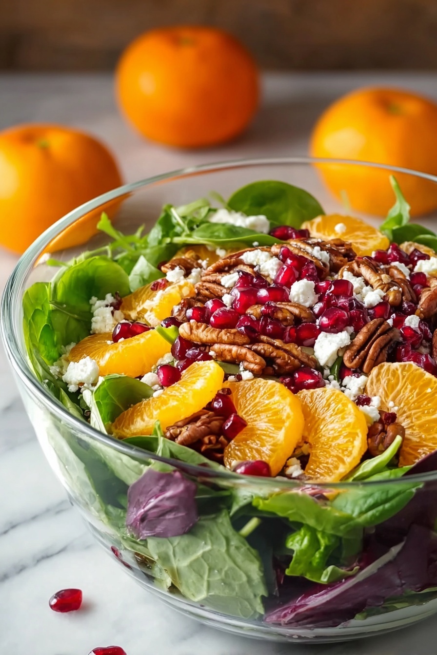 A clear glass bowl is filled with a colorful layered salad. The bottom layer is fresh green spinach and mixed greens with some purple leaves scattered in. On top, bright orange mandarin slices are placed evenly, along with deep red pomegranate seeds scattered around. There are also brown pecan halves spread throughout. Small white crumbles of cheese are sprinkled over the top, adding contrast. The bowl sits on a white marbled surface with two whole mandarins blurred softly in the background. The image has a natural light setting, highlighting the fresh and vibrant colors of the salad. Photo taken with an iphone --ar 2:3 --v 7 - Festive Orange Pomegranate Salad, holiday fruit salad, easy holiday salad, healthy winter salad, colorful fruit salad