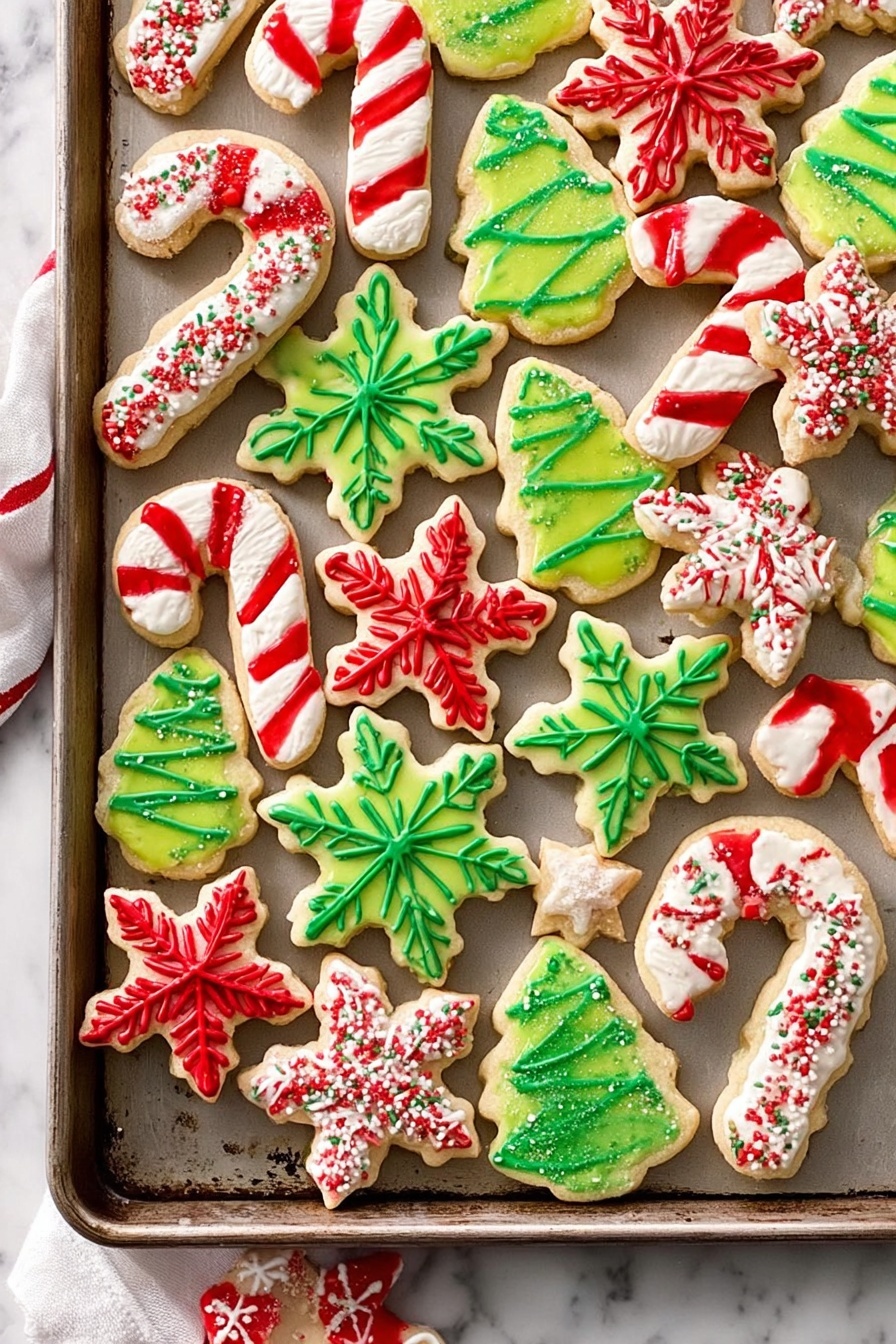 The image shows a tray full of colorful Christmas cookies arranged randomly on a baking sheet placed on a white marbled surface. There are three main shapes: snowflakes, stars, and candy canes, along with green Christmas tree shapes. The snowflake cookies have a white base with red or green icing forming their intricate snowflake patterns. The star-shaped cookies are filled with either green or red icing, each with a zigzag of white icing on top. The candy cane cookies are white with red stripes, and the Christmas tree cookies are green with white or red icing shaped like garlands or decorations. The colors are bright and festive, creating a joyful holiday feeling. photo taken with an iphone --ar 2:3 --v 7 - Vanilla Sugar Cookies, classic sugar cookie recipe, easy vanilla cookies, soft sugar cookies with vanilla, homemade vanilla cookies