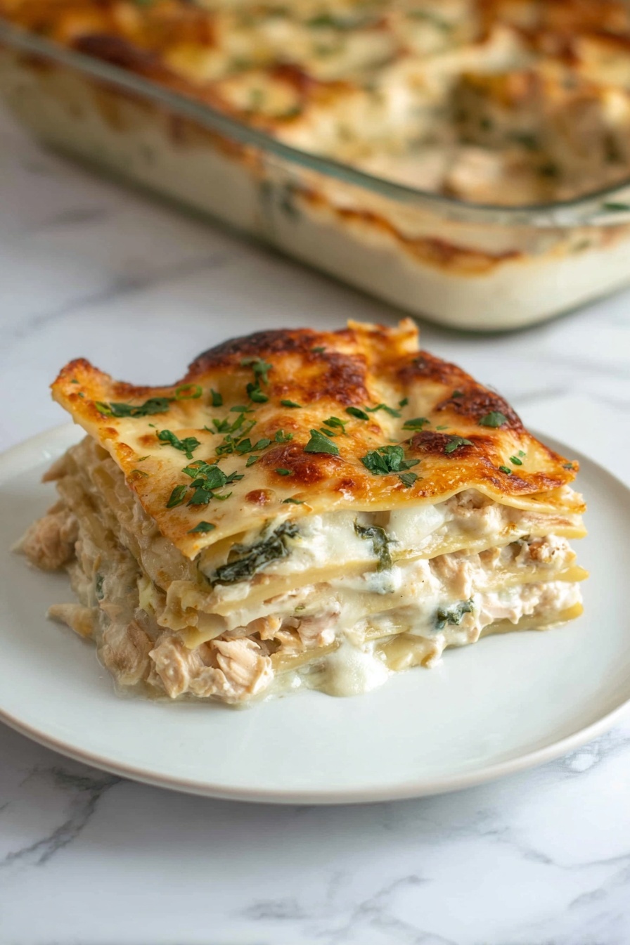 The image shows a glass baking dish filled with a lasagna that has several visible layers. The bottom layer is a red tomato sauce with some herbs, topped by a smooth creamy white cheese layer. Above that, there are pasta sheets with a beige color and wavy edges, followed by more tomato sauce and cheese layers. The top layer is golden brown melted cheese sprinkled with small green parsley pieces. The dish rests on a white marbled surface with a dark blue striped cloth in the background and a white pot with green plants nearby. Photo taken with an iphone --ar 2:3 --v 7 - Creamy Chicken Alfredo Lasagna, creamy chicken lasagna, chicken alfredo pasta bake, cheesy chicken lasagna, easy chicken lasagna