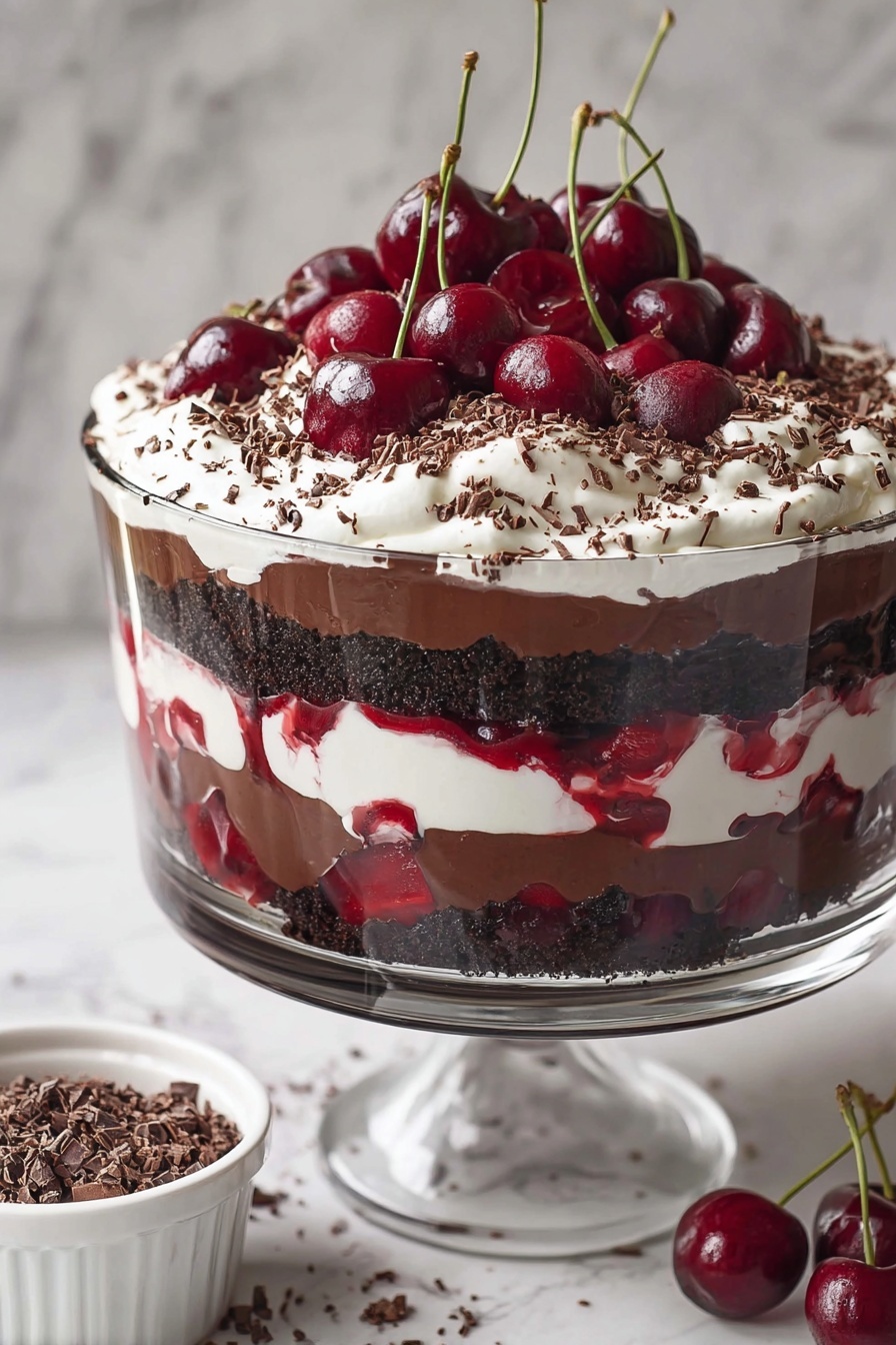 A clear glass dessert cup shows a layered cherry chocolate dessert. The bottom layer is dark chocolate pudding with whole cherries visible through the glass. Above this is a mix of cherry sauce and small chunks of dark chocolate cake. On top, there is a thick layer of white whipped cream sprinkled with dark brown chocolate shavings. Two whole cherries, one with a long stem, sit on the whipped cream. A woman's hand holds a spoon digging into the dessert. The scene is set on a white marbled surface with whole cherries and a white cloth nearby. Photo taken with an iphone --ar 2:3 --v 7 - Black Forest Cherry Trifle, cherry chocolate dessert, layered dessert recipe, easy trifle ideas, holiday dessert recipes