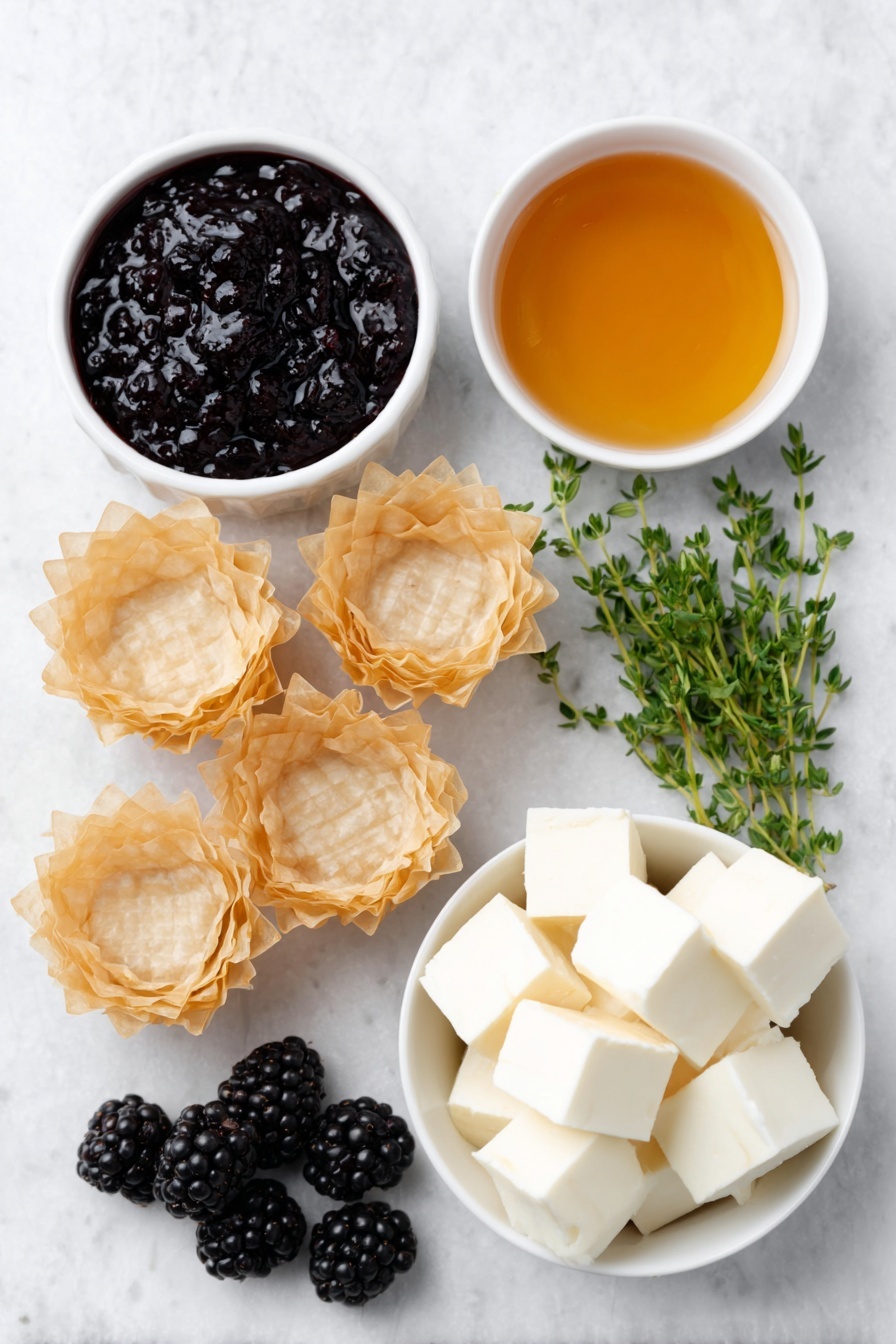 Flat lay of fresh golden mini phyllo shells arranged neatly, a small white ceramic bowl with glossy deep purple blackberry jam, another small white bowl filled with clear golden honey, creamy pale off-white cubes of brie cheese without rind, a handful of plump fresh blackberries with a rich dark purple hue, and a few sprigs of vibrant green fresh thyme artfully placed, all ingredients balanced symmetrically and naturally placed on a clean white marble surface, soft natural light, photo taken with an iPhone, professional food photography style, fresh ingredients, white ceramic bowls, no bottles, no duplicates, no utensils, no packaging --ar 2:3 --v 7 --p m7354615311229779997 - Brie and Blackberry Phyllo Cups, Brie and Blackberry Appetizer, easy brie and blackberry tartlets, quick party appetizers with brie, elegant blackberry phyllo bites