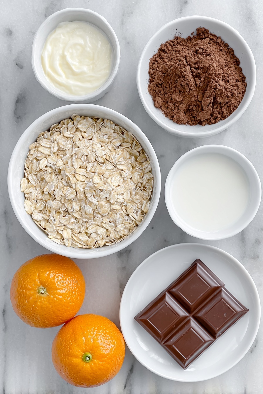 Flat lay of a small white ceramic bowl filled with pale beige porridge oats, a small white bowl of creamy semi-skimmed milk, a small white bowl of clear water, a small white bowl of rich dark brown cocoa powder, two bright orange satsumas—one whole and one cut in half showing juicy segments, and a single square of glossy dark chocolate placed on a white ceramic plate, all arranged in perfect symmetry, placed on a clean white marble surface, soft natural light, photo taken with an iPhone, professional food photography style, fresh ingredients, white ceramic bowls, no bottles, no duplicates, no utensils, no packaging --ar 2:3 --v 7 --p m7354615311229779997 - Chocolate Orange Porridge, breakfast ideas with orange and chocolate, easy healthy porridge recipes, cozy morning breakfast, citrus chocolate oatmeal