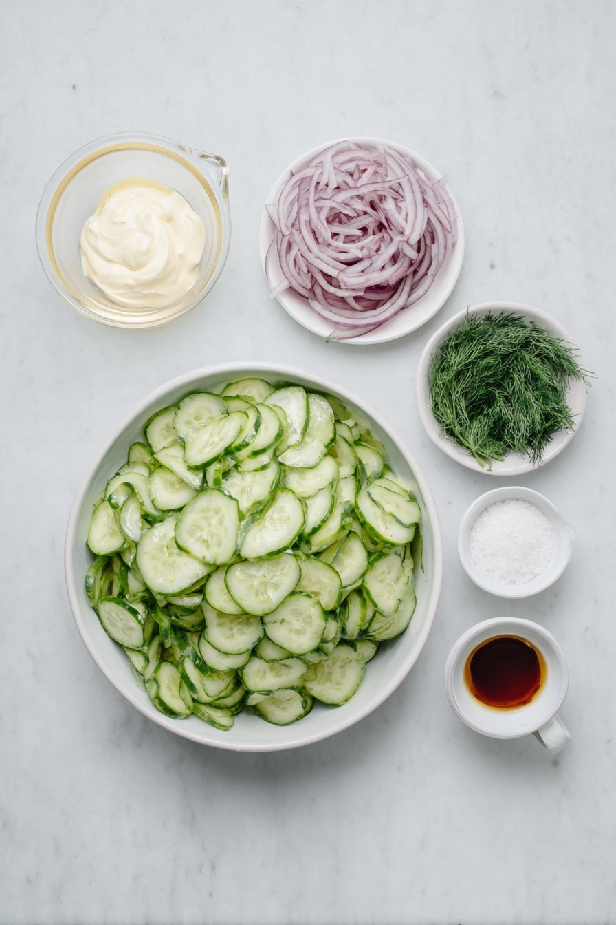 Flat lay of a small pile of thinly sliced pale green cucumbers, a small pile of thinly sliced vibrant red onion rings, a small white ceramic bowl filled with smooth sour cream, a small white ceramic bowl holding clear white vinegar, a few sprigs of bright fresh dill, a small white ceramic bowl of fine granulated white sugar, a small white ceramic bowl with coarse white salt crystals, a small white ceramic bowl containing light beige garlic powder, placed on a clean white marble surface, soft natural light, photo taken with an iPhone, professional food photography style, fresh ingredients, white ceramic bowls, no bottles, no duplicates, no utensils, no packaging --ar 2:3 --v 7 --p m7354615311229779997 - Creamy Cucumber Salad, cucumber salad, easy cucumber side dish, healthy cucumber salad, refreshing cucumber salad